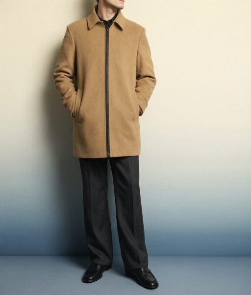 Minimalist Camel Ensemble Man wearing a camel-colored zip-front coat, black trousers, and loafers against a gradient wall.