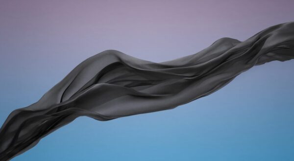 Elegant Black Silk Draped In Motion Elegant black silk fabric flowing gracefully against a soft purple-to-blue gradient sky.