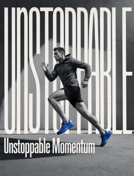 Runner In Motion Through Urban Grit A male runner in motion wearing dark athletic gear and bright blue shoes against a gray urban backdrop with bold white text overlay.